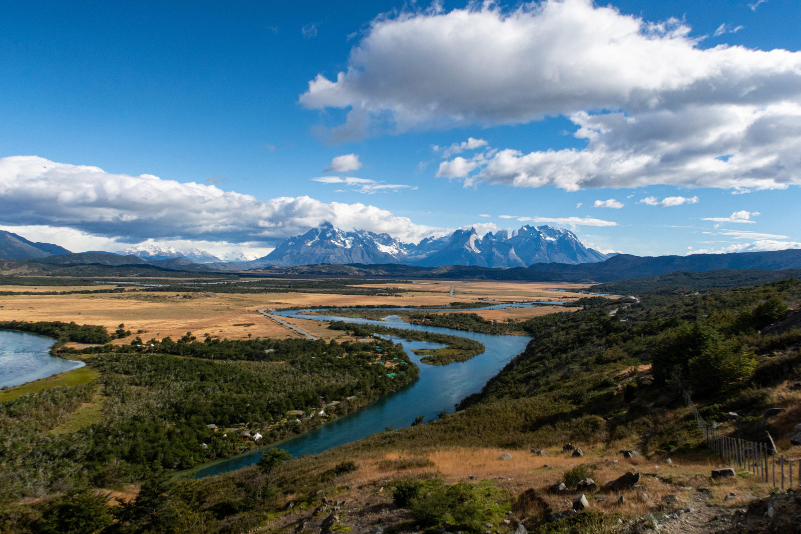 View from Mirador Río Serrano showing the Río Serrano winding through the Patagonian landscape with the Paine Massif mountains in the distance, Torres del Paine National Park, Chile.