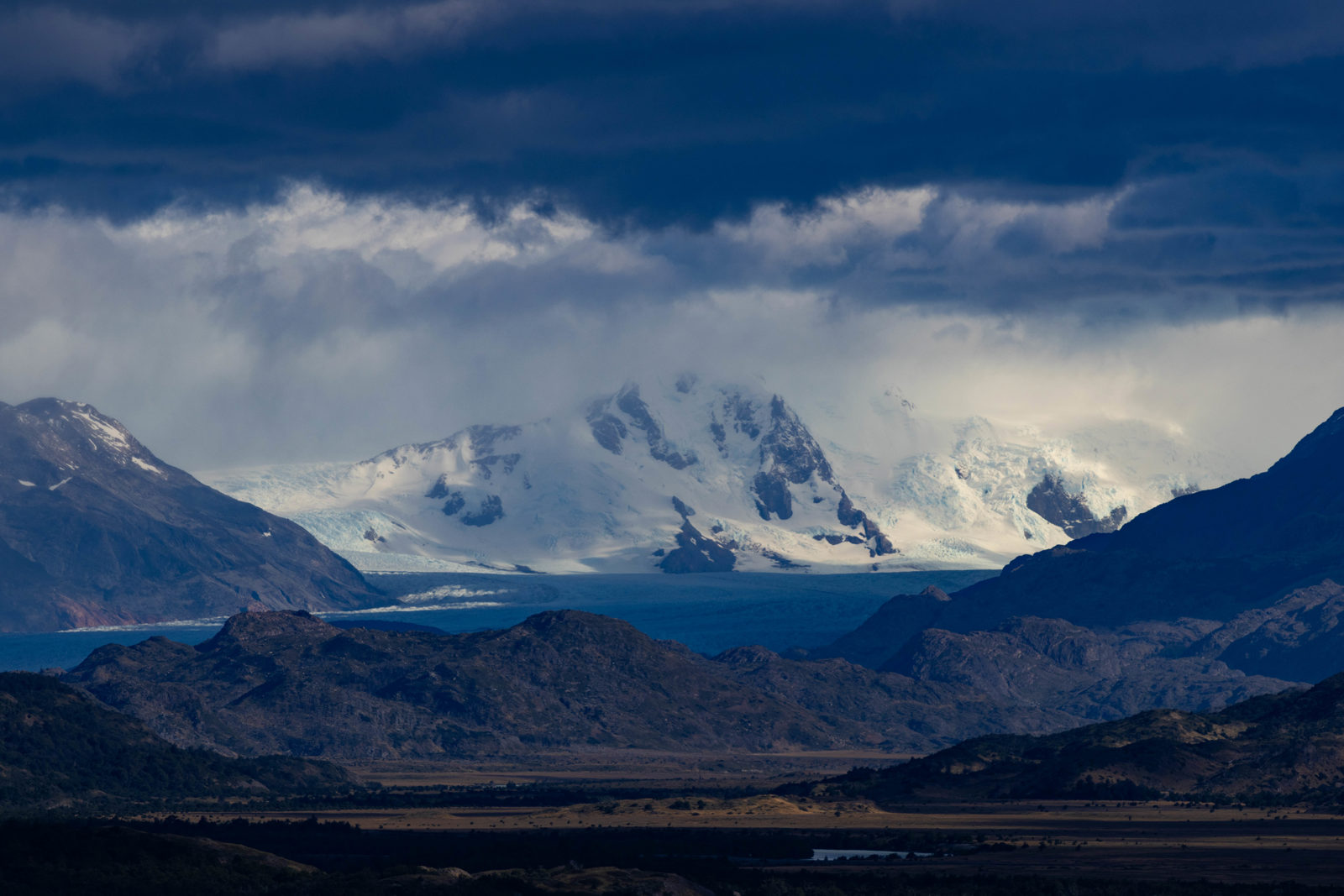 Grey Glacier and the Southern Patagonian Ice Field beneath dramatic storm clouds, viewed from a lookout near the entrance to Torres del Paine National Park, Chile.