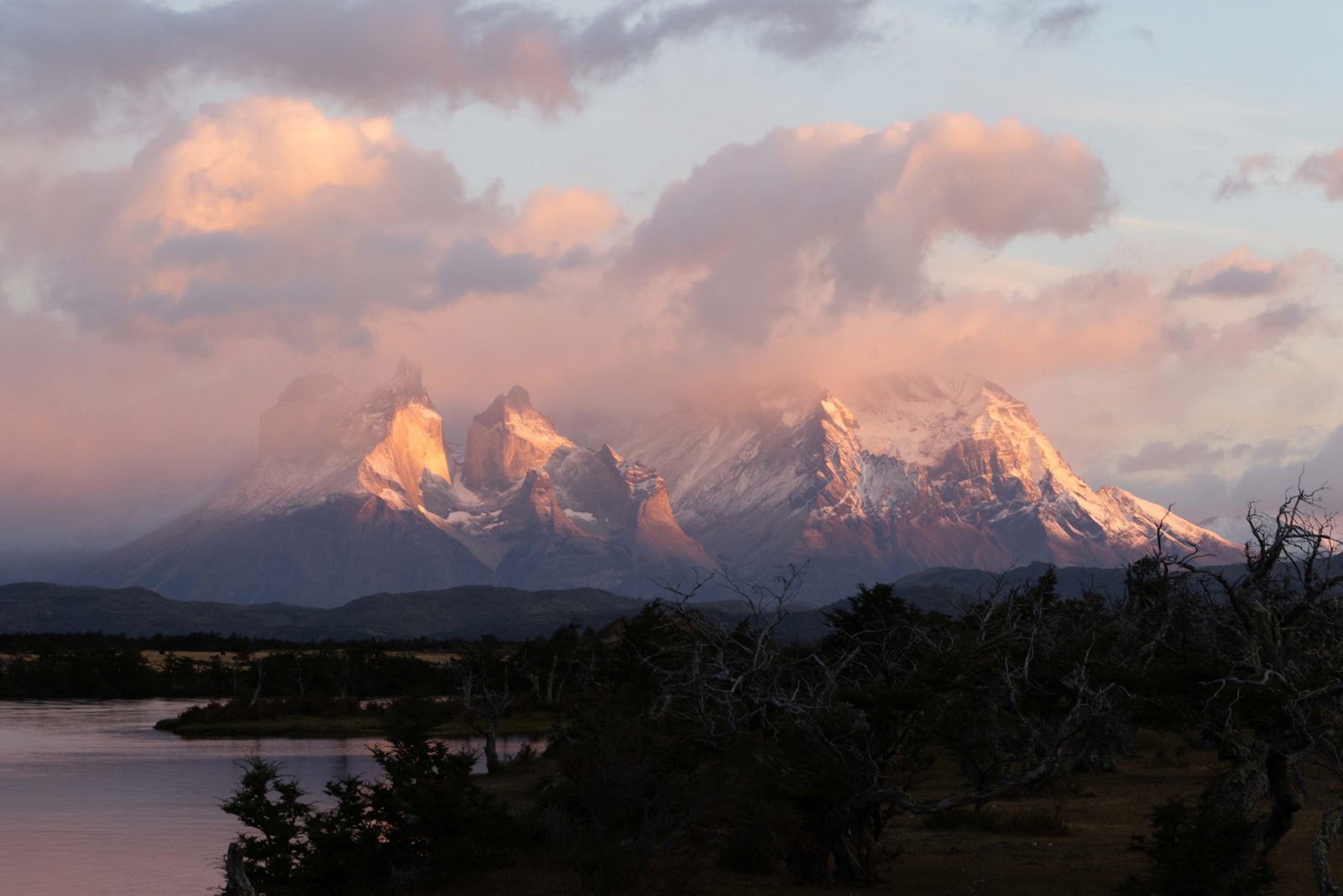Sunrise light illuminating the Cuernos del Paine and Paine Grande peaks in Torres del Paine National Park, Patagonia, Chile.
