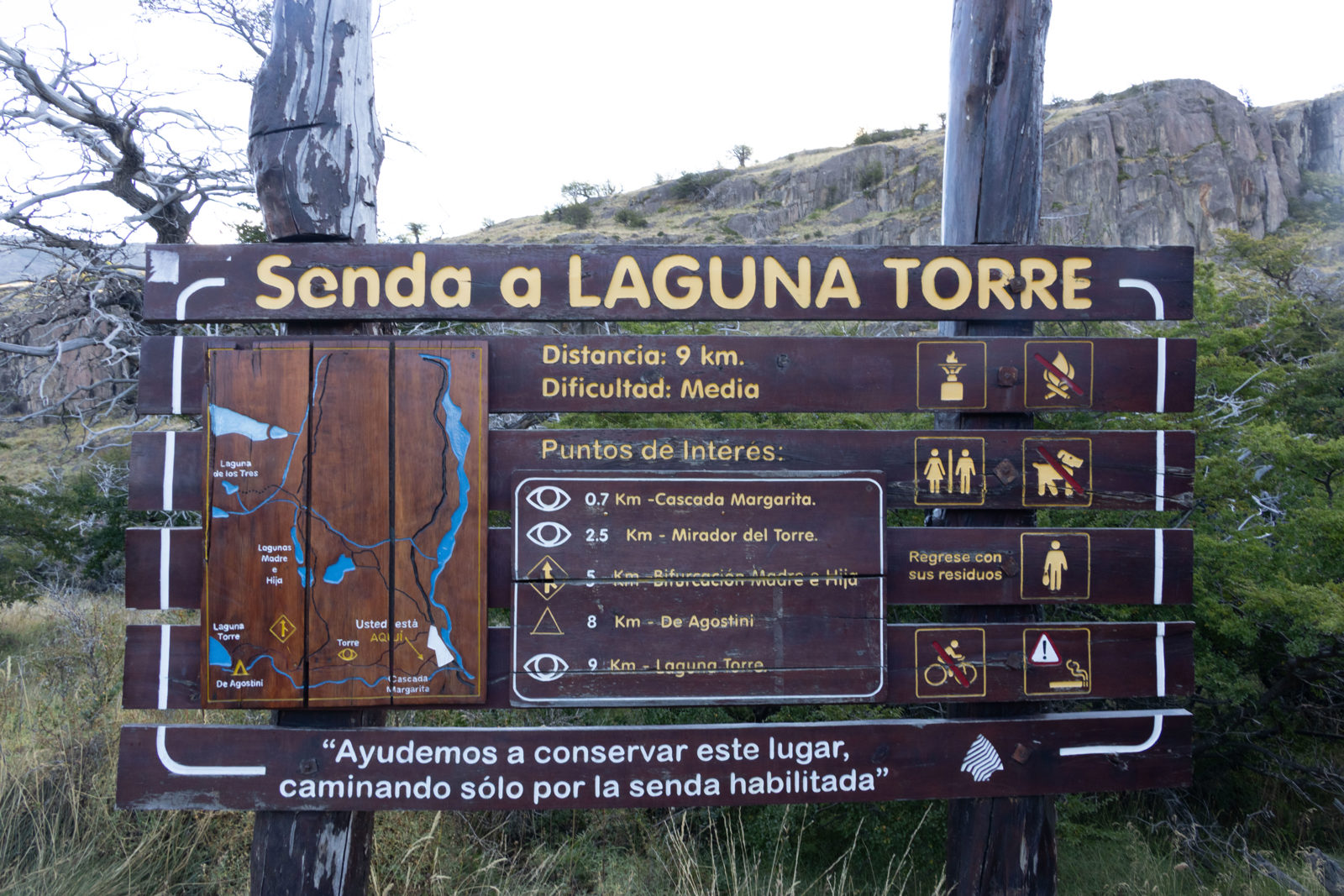 Official Laguna Torre trailhead information sign in El Chaltén showing the hiking route, distance and points of interest in Los Glaciares National Park, Argentina.