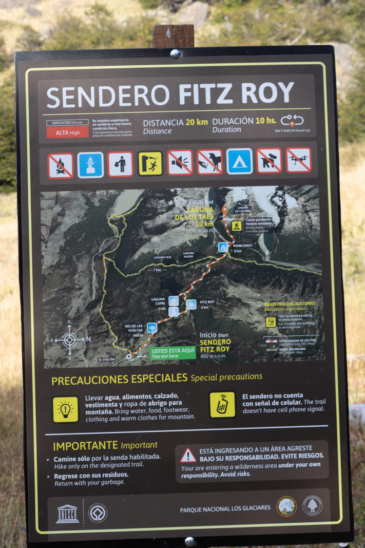 Information board at the Sendero Fitz Roy trailhead in El Chaltén showing the route to Laguna de los Tres, distance, duration and safety advice.