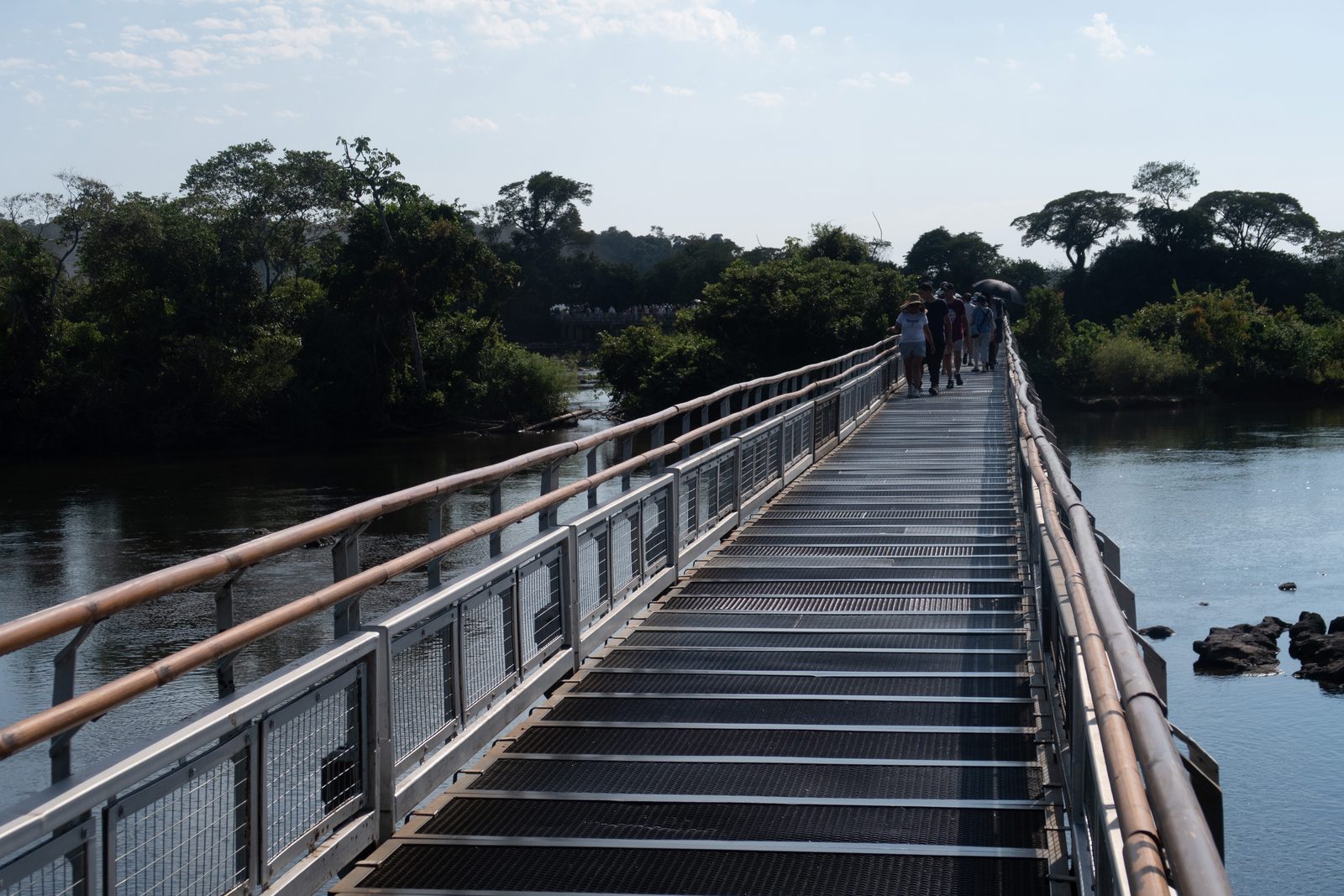 Elevated boardwalk across the Upper Iguazú River leading towards Devil's Throat in Iguazú National Park, Argentina.