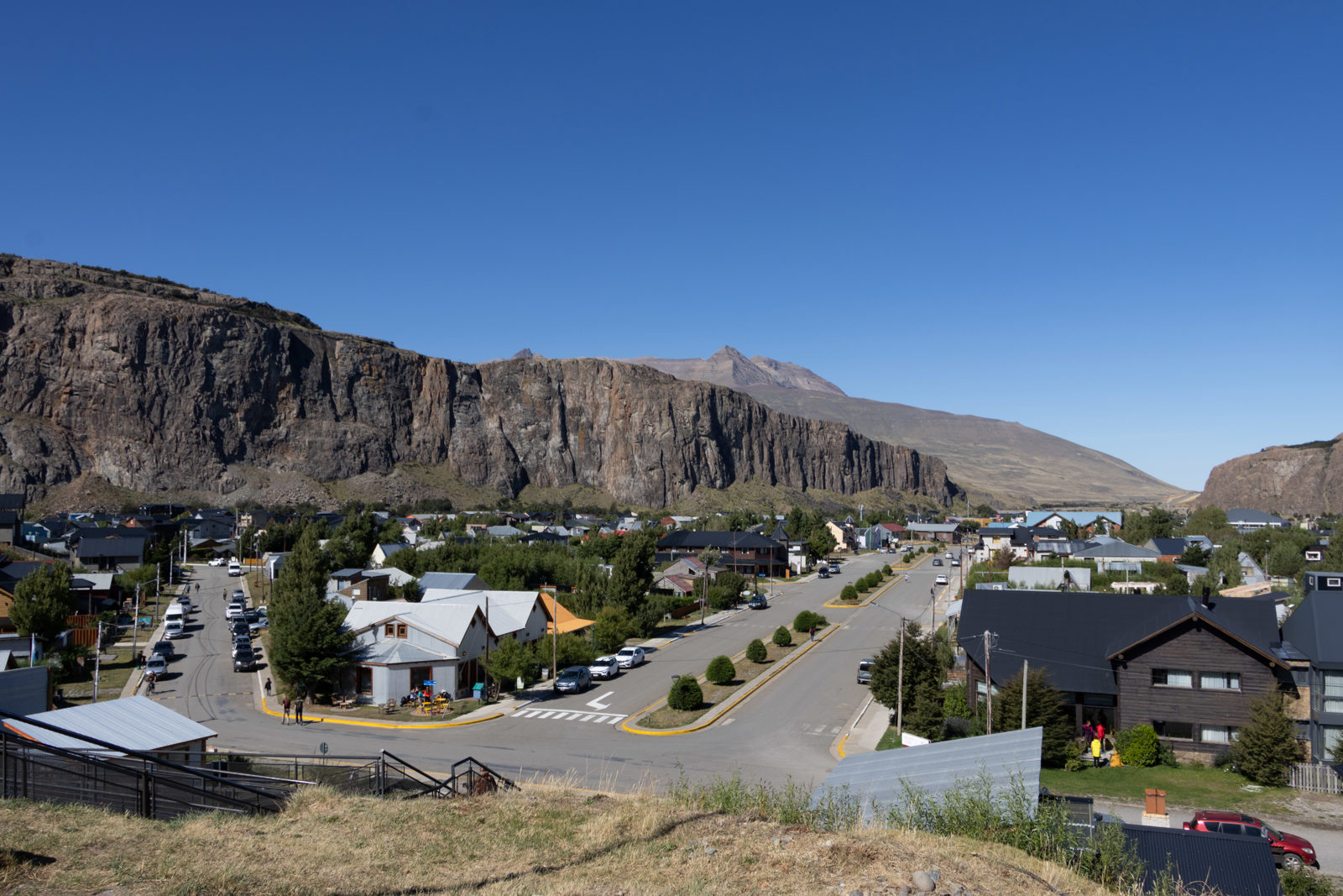 View across El Chaltén towards the cliffs and mountains before setting out on the Laguna Torre hiking trail in Patagonia, Argentina.