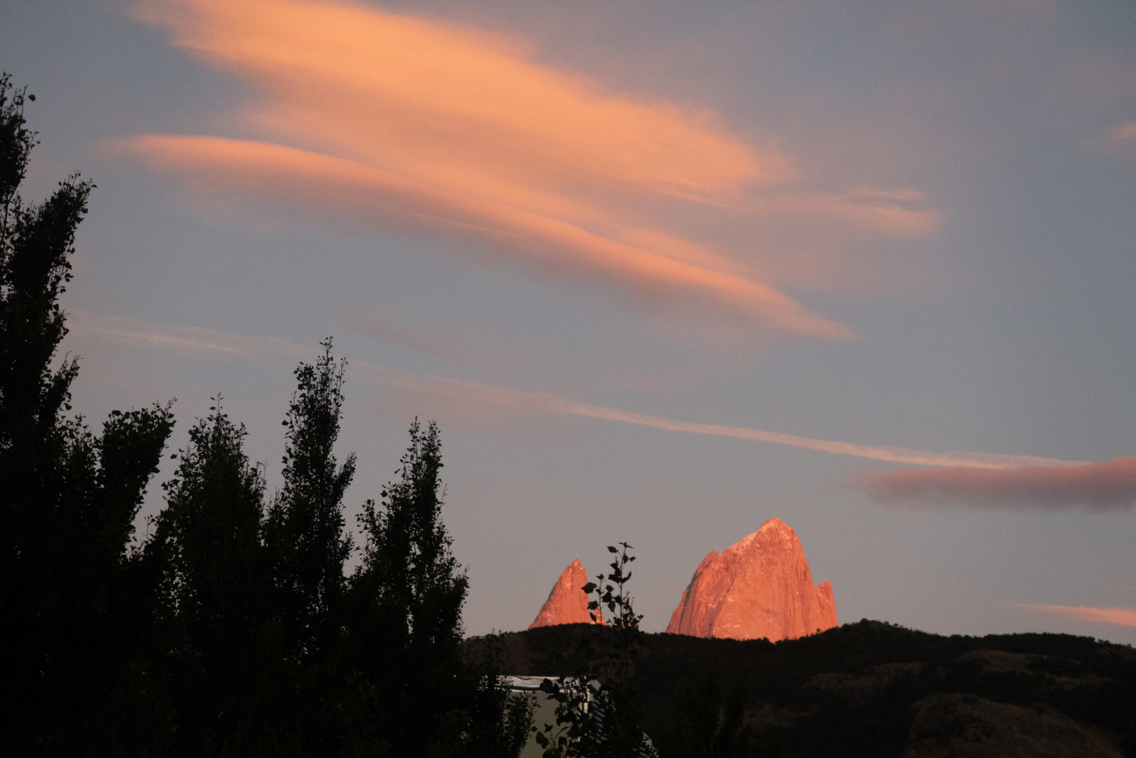 Early morning light catching the granite towers of Fitz Roy above El Chaltén during the start of the Laguna de los Tres hike.