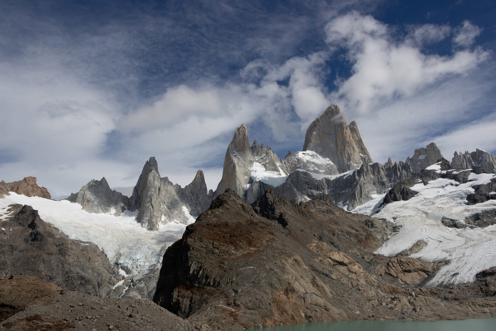 Wide view of Fitz Roy, surrounding granite spires and glaciers rising above Laguna de los Tres in Patagonia.
