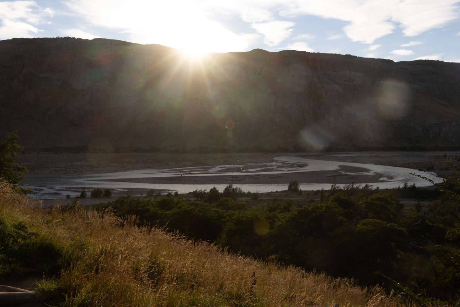 Morning sun breaking over the valley above Río de las Vueltas on the early climb of the Fitz Roy trail near El Chaltén.