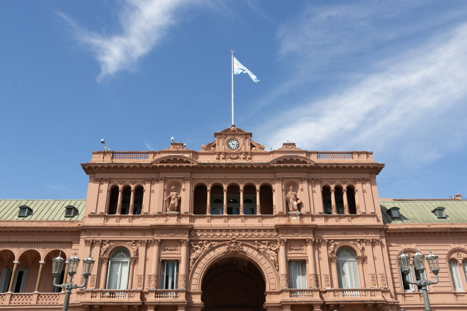 Casa Rosada in Buenos Aires with the Argentine flag flying above the central balcony.