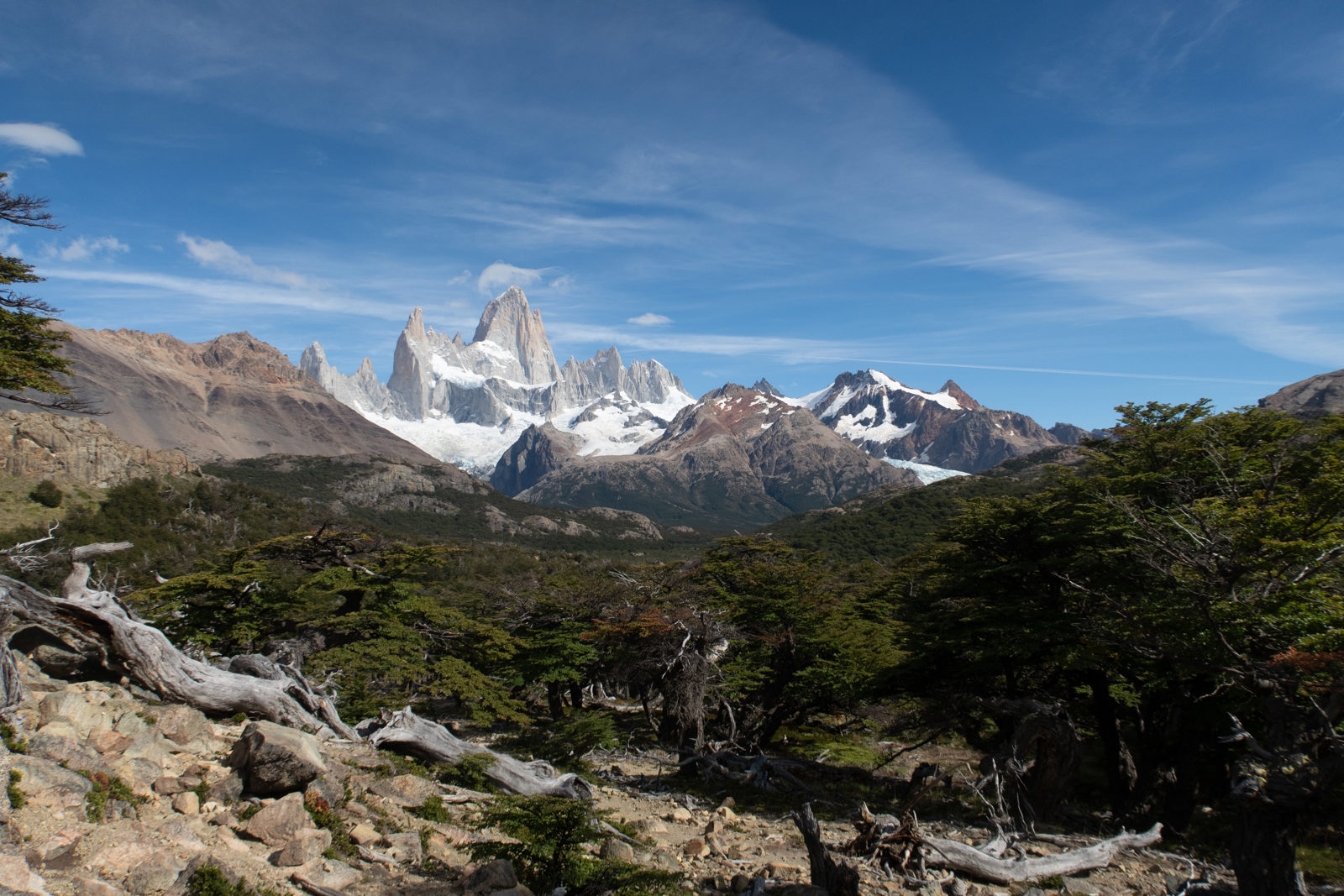 View of the Fitz Roy massif from Mirador Fitz Roy, with rocky foreground and lenga woodland on the trail from El Chaltén.