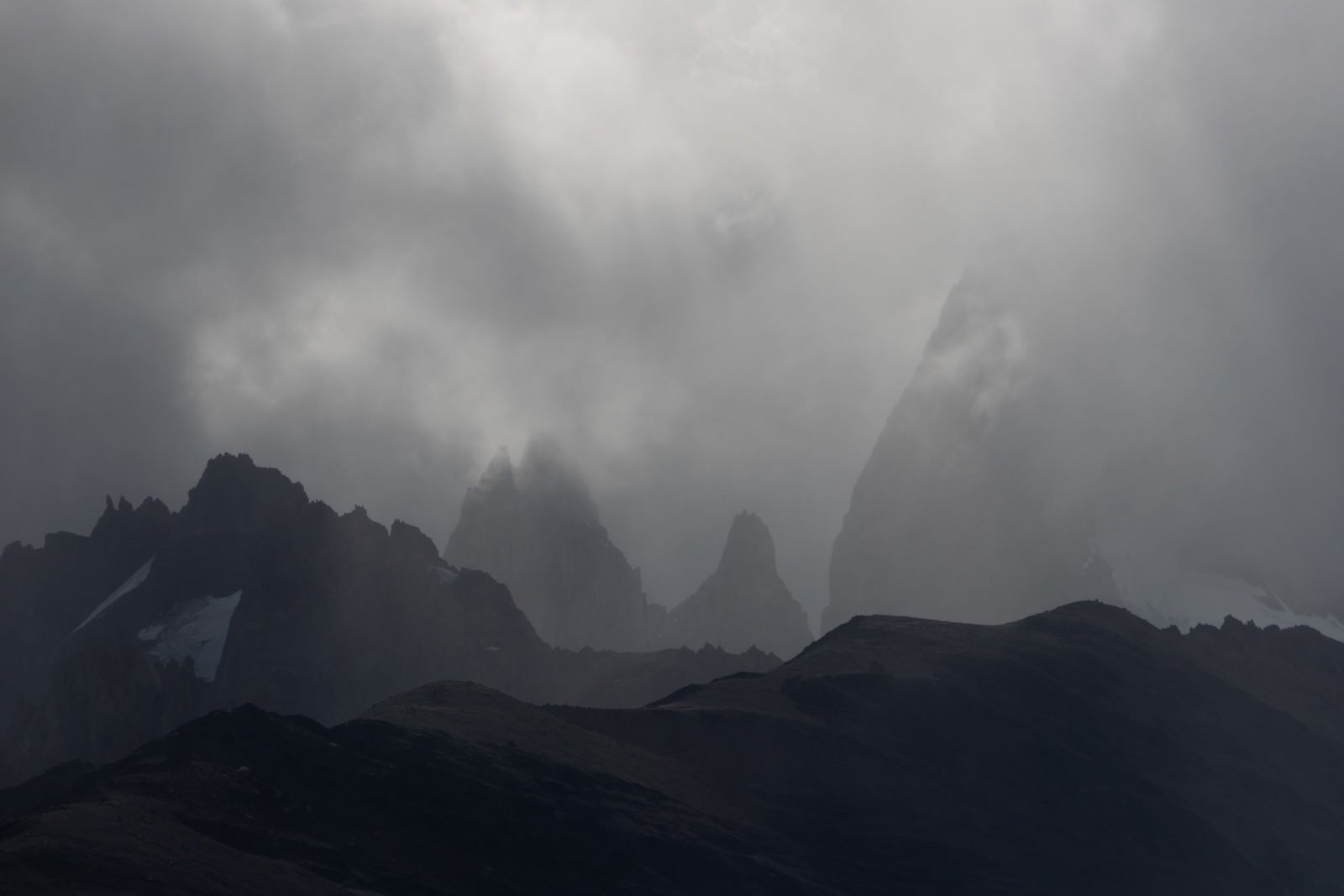 Fitz Roy massif partly hidden by cloud and mist above El Chaltén in Patagonia.