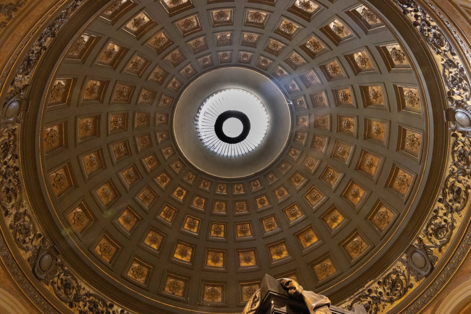 Interior dome of Buenos Aires Metropolitan Cathedral with decorative panels and central skylight.
