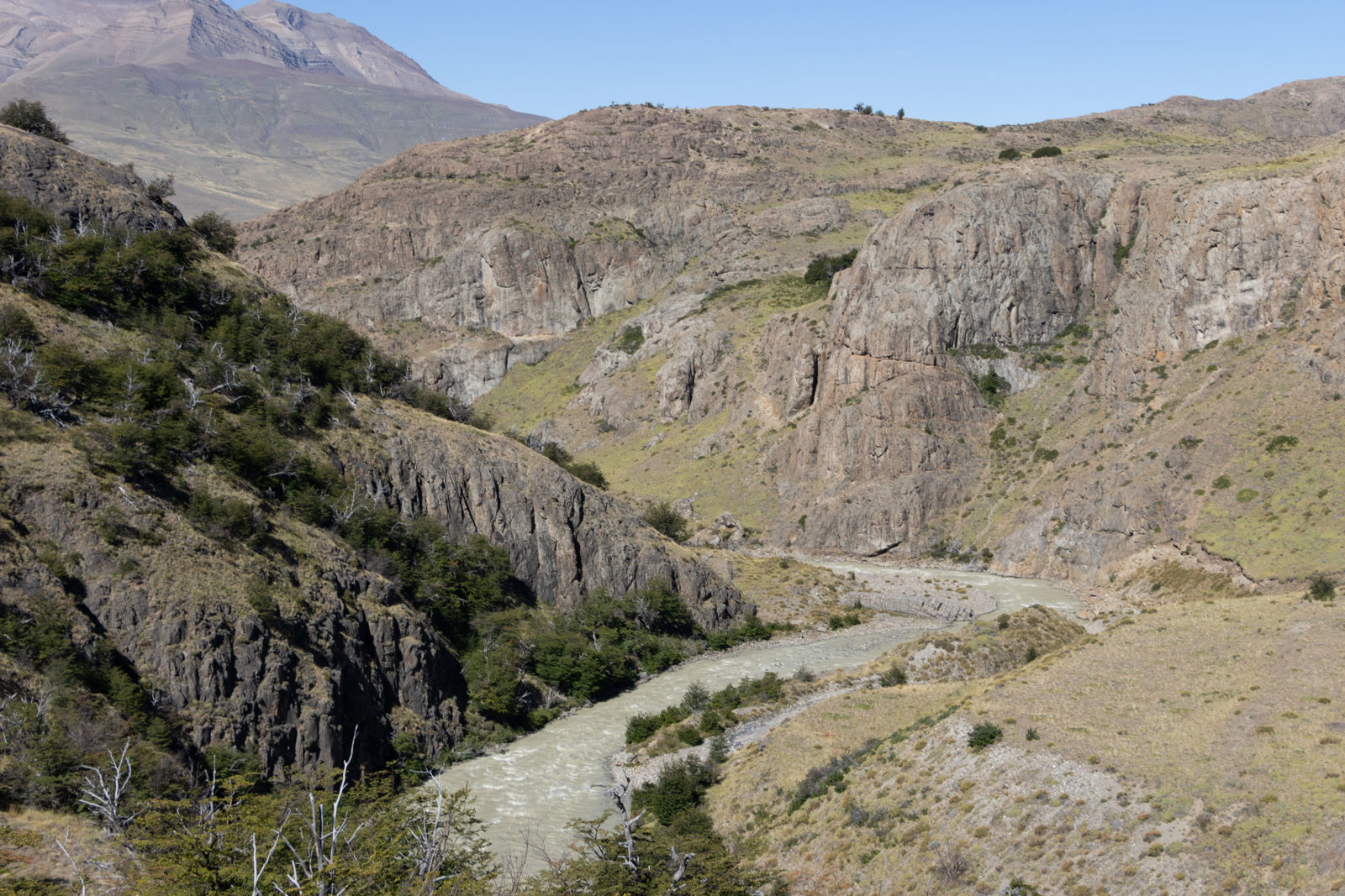 The Laguna Torre hiking trail follows a glacial river through the rugged valley below the Cerro Torre Massif near El Chaltén, Patagonia, Argentina.