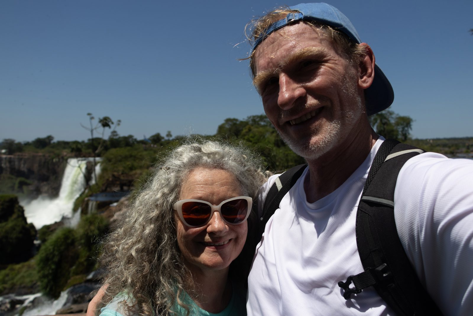 Couple overlooking Iguazú Falls in Iguazú National Park, Argentina.