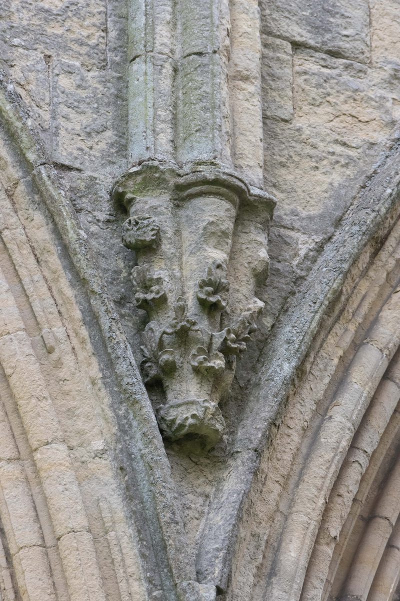 Weathered carved face set into stonework at Rievaulx Abbey