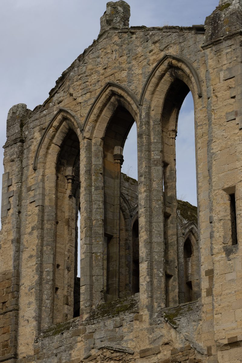 Tall pointed window openings in a stone wall at Rievaulx Abbey
